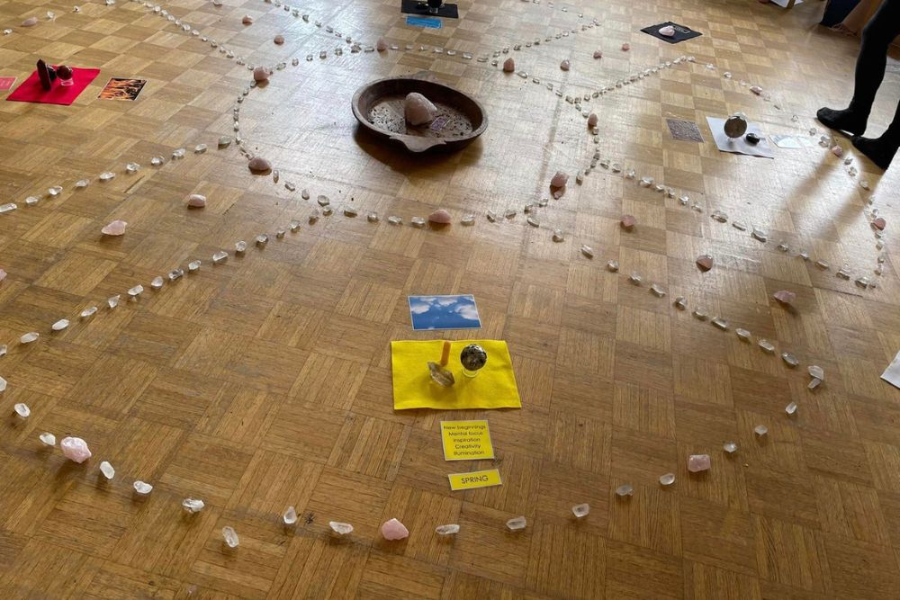 A wooden floor with crystals placed following a sacred geometry pattern